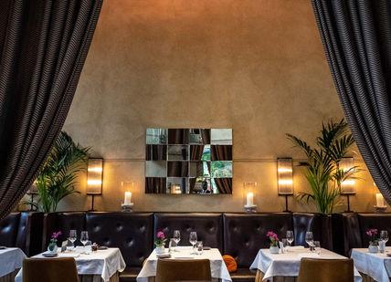 An image of a restaurant with a large mirror, La Chapelle. Galvin