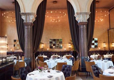 An image of a restaurant with tables and chairs, La Chapelle. Galvin