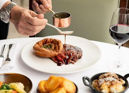 An image of a person eating food,  3 course Sunday Lunch. Galvin at Windows