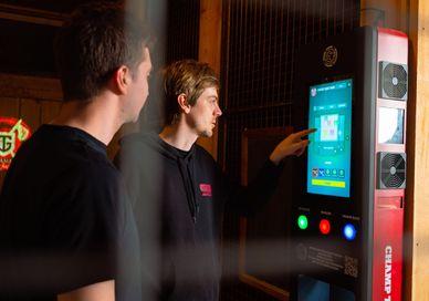 An image of a man using a vending machine, One Hour UV Glow Axe Throwing. Game of Throwing