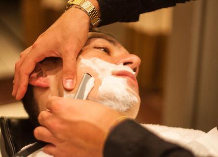 An image of a man getting his hair cut, Traditional Haircut, Wet Shave & Prep Facial. Gentlemen's Tonic