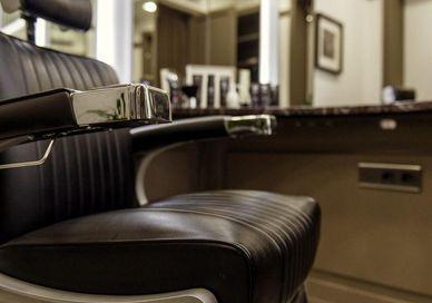 An image of a barber chair in a salon, Traditional Haircut, Wet Shave & Prep Facial. Gentlemen's Tonic