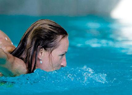 An image of a girl swimming in a pool, Seven-Night Mayr Health Retreat. Gesundheitszentrum Igls GmbH (Parkhotel Igls)