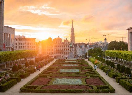 The sun is setting over the city of brussels in brussels, belgium.