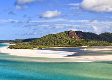 An image of a beach with a mountain in the background, Diving and Spearfishing on the Great Barrier Reef. Getaway-Pseudo-Supplier
