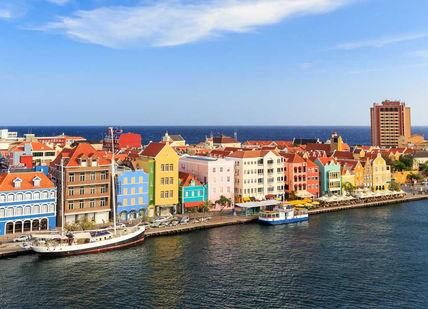 An image of a city with colorful buildings, Four-night stay in a 4-star resort in Willemstad.