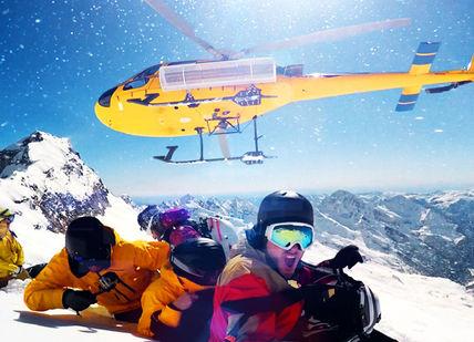 An image of a helicopter flying over a group of people, Heli-Skiing, Snowmobiling and Olympic Legacies. Getaway-Pseudo-Supplier