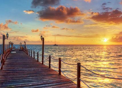 An image of a dock at sunset, Luxury Sailing Yacht Charter in the Bahamas. Getaway-Pseudo-Supplier