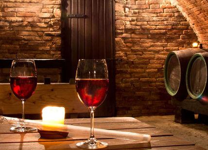 An image of a wine cellar with wine glasses and a candle, Napa Valley Wine And Gastronomy Getaway. Getaway-Pseudo-Supplier