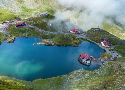 An image of a mountain lake surrounded by clouds, One night in a 5 star hotel in Sibiu.