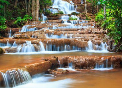An image of a waterfall in the jungle, Private Seven-Day Tour of Angkor Wat, Phnom Kulen & Lake Tonle Sap. Getaway-Pseudo-Supplier