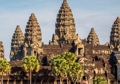 An image of a large building with palm trees, Private Seven-Day Tour of Angkor Wat, Phnom Kulen & Lake Tonle Sap.