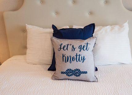 An image of a bed with a pillow, Three Night Oak Island Getaway. Getaway-Pseudo-Supplier