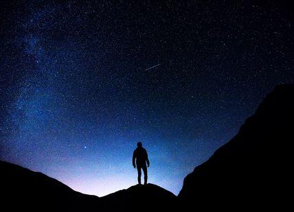 An image of a person standing on a mountain, Stargazing and Two-Night Stay. Glenapp Castle