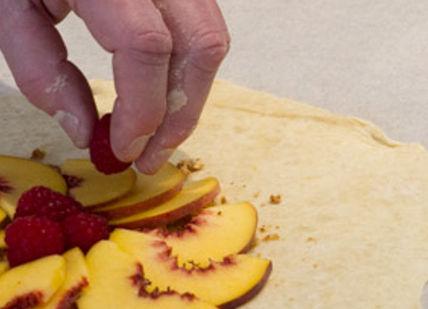 An image of a person making a fruit pizza, Pastry and Pie Making Class. Greenwich Pantry