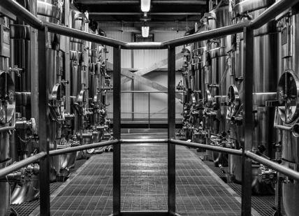 An image of a long hallway with metal pipes, Hambledon Vineyard. Hambledon Vineyard