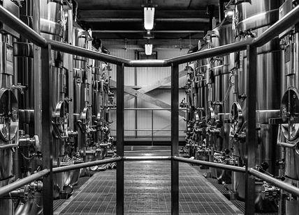 An image of a long hallway with metal pipes, Hambledon Wineries Ltd. Hambledon Wineries Ltd
