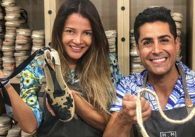 An image of a man and woman holding up a snake, Classic Espadrilles Online Workshop. Handmade Barcelona