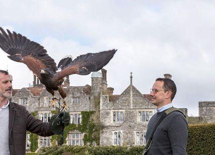 An image of two men with a bird on their arm, Private Full-Day Falconry Experience. The Hawking Centre