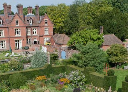 An image of a large house in the middle of a garden, The Hawking Centre. The Hawking Centre