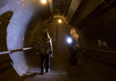 An image of a person walking down a dark tunnel, Private Secret Underground Tour. Hidden London