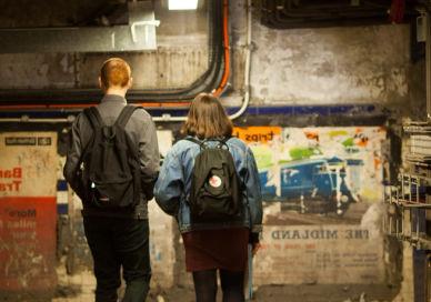 An image of a man and woman walking in a tunnel, Secret Underground Public Tour. Hidden London
