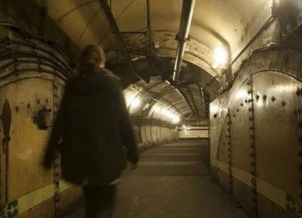 An image of a man walking down a tunnel, Secret Underground Tour of Down Street. Hidden London