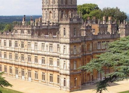 An image of a castle with trees in the fore, Behind-The-Scenes Tour Of Downton Abbey With Private Dining. Highclere Castle