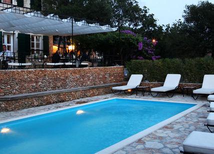An image of a pool with chairs and umbrellas, Discover Croatian Gastronomy on the trails of Anthony Bourdain. Hotel Boskinac