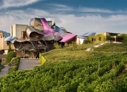 An image of a building with a pink roof, Spain Wine Break Hotel Transfer. Hotel Marques de Riscal