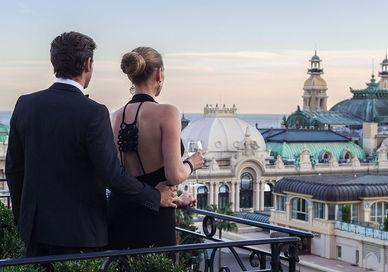 An image of a couple on a balcony, Golden Eye Package. Hotel Metropole Monaco