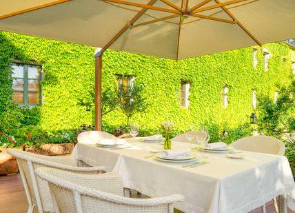An image of a patio setting with a table and chairs, Santiago Getaway. Hotel A Quinta Da Auga