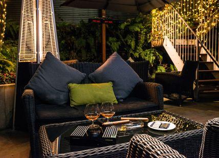 An image of a patio setting with a table and chairs, Cigar and Whisky Pairing Masterclass . Hotel Xenia, Autograph Collection 