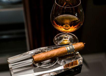 An image of a cigar and a glass of wine, Cigar and Whisky Pairing Masterclass . Hotel Xenia, Autograph Collection 