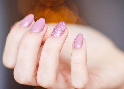 An image of a woman with a pink manicure, Opi Prospa Pamper Manicure With Prosecco. Images London