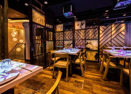 An image of a restaurant setting with tables and chairs, Sushi and Sake Masterclass. inamo Restaurants