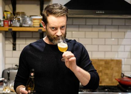 An image of a man in the kitchen, Home Beer & Cheese Matching Experience. James Kellow