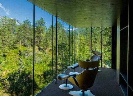 An image of a chair in the middle of a room with a view of the mountains, Three nights with breakfast and dinner. Juvet Landscape Hotel