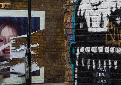 An image of a person walking down a street, Discover Street Art on a Tour. Karim Samuels - Insider