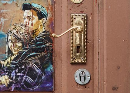 An image of a woman on a door, Discover Street Art on a Tour. Karim Samuels - Insider