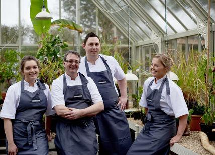 An image of a group of people in a greenhouse, Private Group Tuition. Le Manoir aux Quat'Saisons, A Belmond Hotel