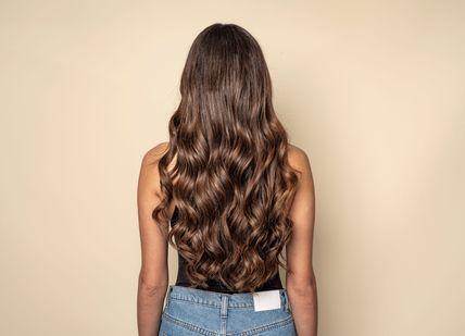 An image of a woman with long brown hair, Shampoo, Head Massage + Blow Dry + Ultimate treatment + FUL Styling Spray (Take Home. Live True London