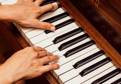 An image of someone playing the piano, Ten Private Piano Lessons. The London Piano Institute