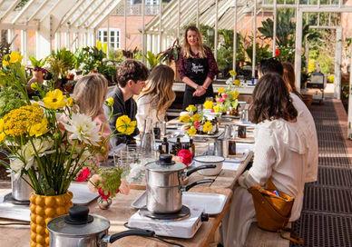 An image of a group of people enjoying in a greenhouse, Curious Roo. The London Refinery