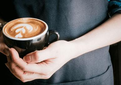 An image of a person holding a cup of coffee, LSC Basic Baritsa Coffee Experience. London School Of Coffee