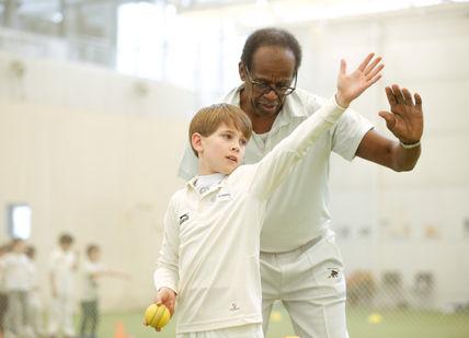 An image of a man and a child playing tennis, Private Children's Lesson. Lord's Indoor Cricket Centre