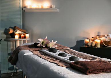 An image of a massage room with candles, Day Spa Delight London. Luenire