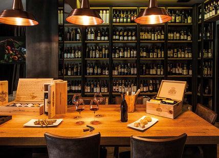 An image of a wine bar with a table and chairs, 2 Night Italian Michelin-Starred Gastronomic Getaway. Lusso e Gusto