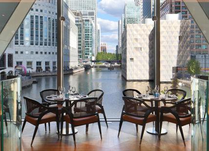 An image of a restaurant with a view of the river, Canary Wharf. M Canary Wharf