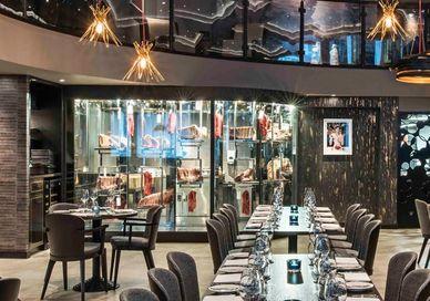 An image of a restaurant with blue booths and tables, Three Courses and Free-Flowing Prosecco at M Threadneedle. M Threadneedle